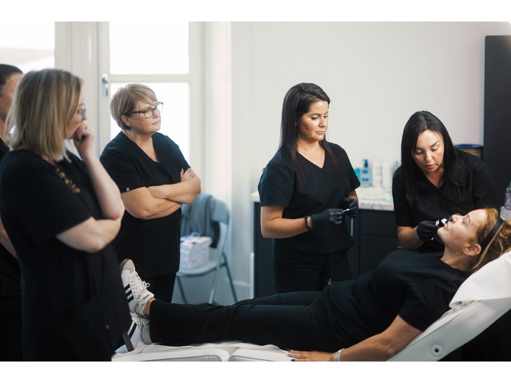 Dr Lauren teaching where to inject botox to a group of students at the Aesthetic Training Academy.