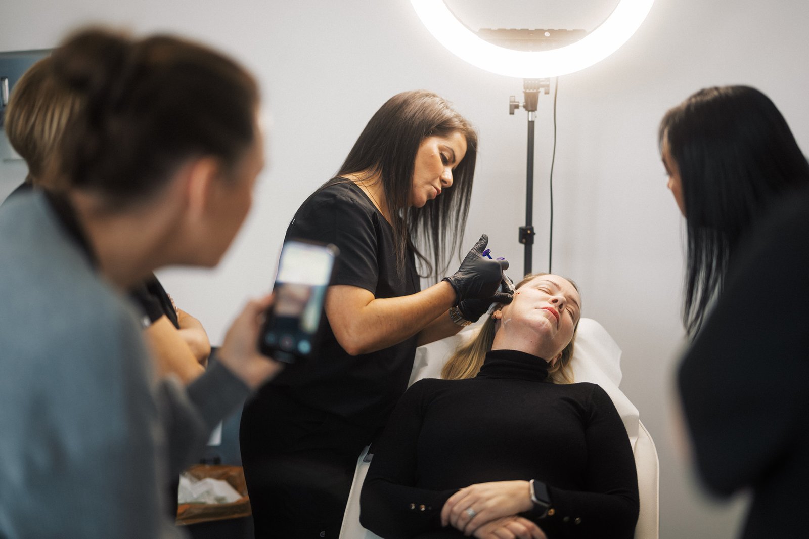 Dr Lauren teaching her students at the ATA where to safely inject botox to a patient's face.