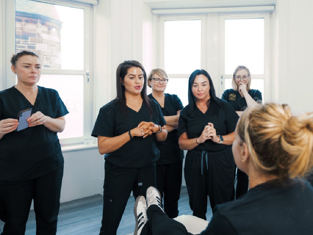 Dr Lauren teaching facial aesthetics to a group of students at the Aesthetic Training Academy.