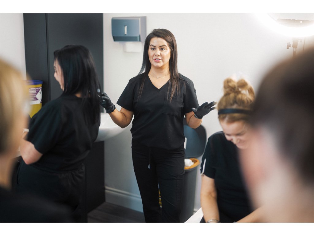 Dr Lauren guiding her students through safe medical aesthetic procedures at the ATA.