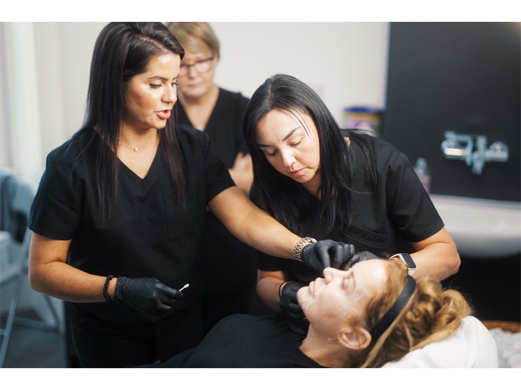 A student receiving one-on-one guidance from Dr Lauren on dermal filler placement.