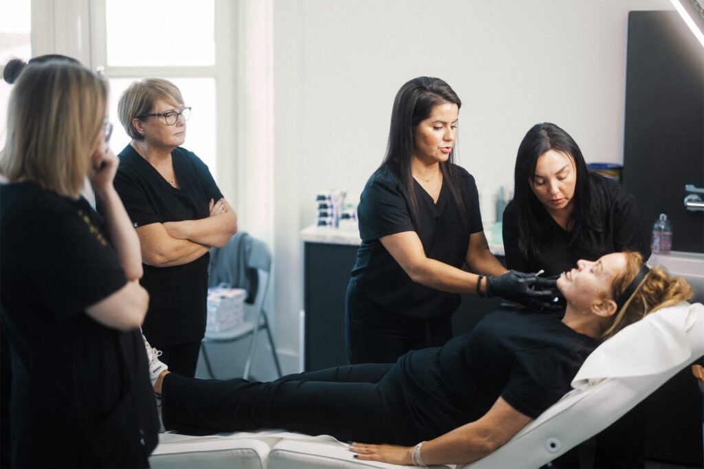 Dr Lauren explaining key injection points for dermal fillers to her students at the ATA.