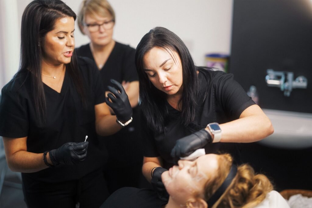 A student learning directly from Dr Lauren how to inject fillers safely.