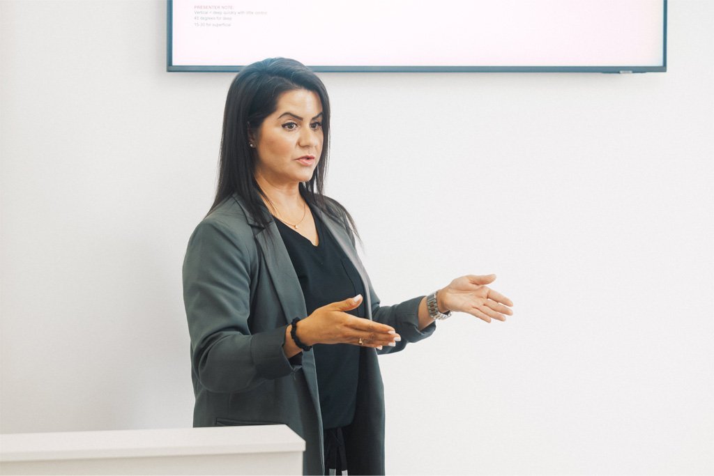Dr Lauren guiding her students at the ATA how to plan aesthetic treatments.