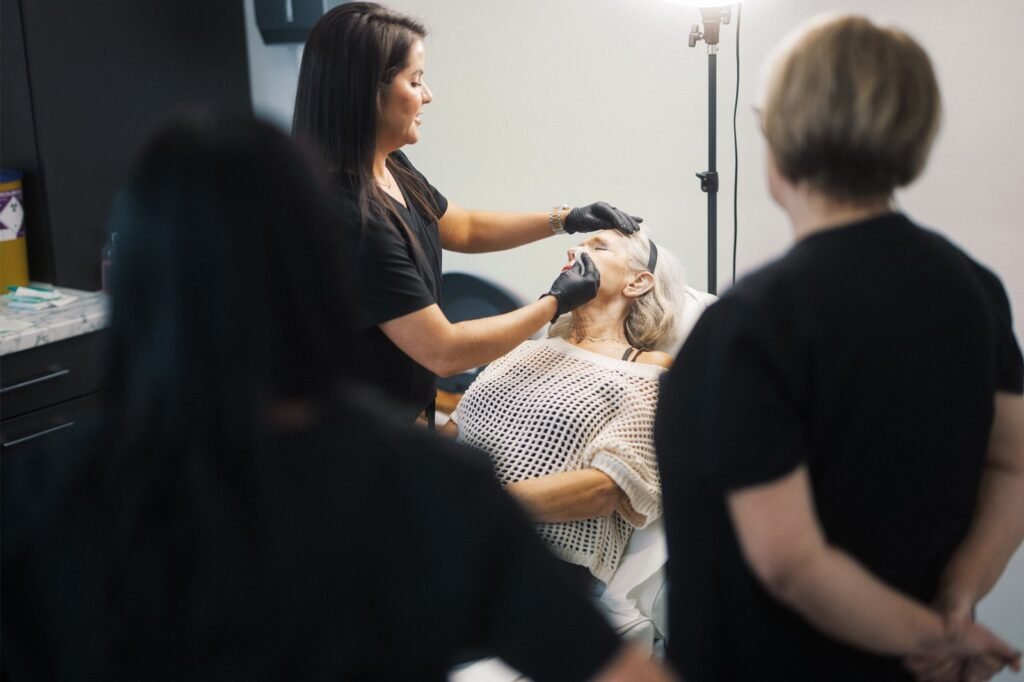 Dr Lauren teaching how to safely administer aesthetic treatments to students at the ATA.