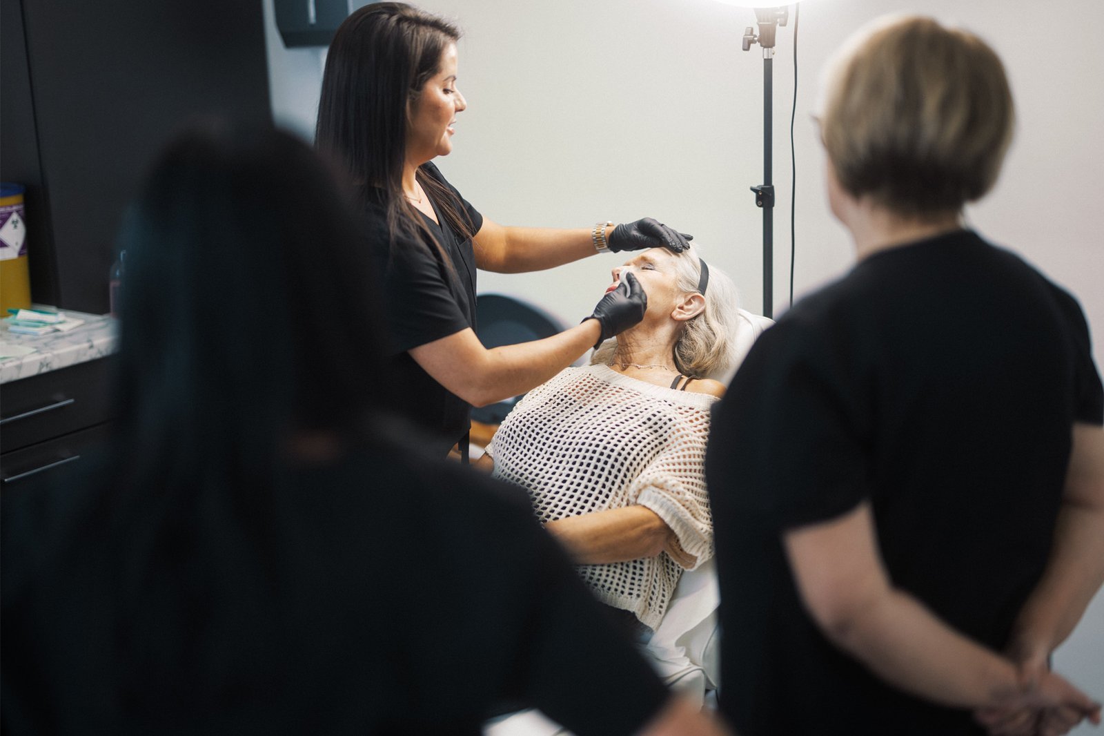 Dr Lauren teaching how to safely administer aesthetic treatments to students at the ATA.